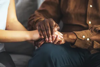 Close up of two people holding hands