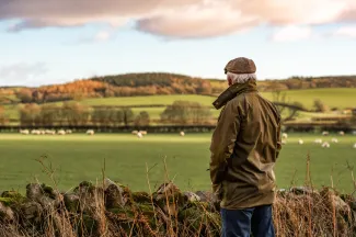 Farmer looking into field