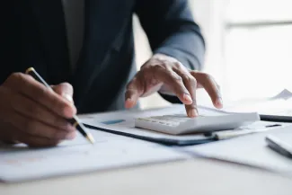 Hands with documents and calculator
