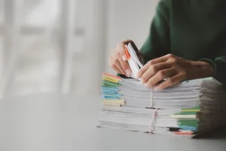 Woman looking through stack of legal documents