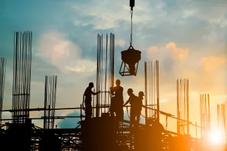 Construction site, with crane and sunset