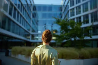 Business woman standing outside building holding papers