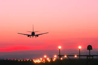 Plane landing at sunset