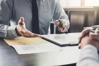 Two people at desk in dispute