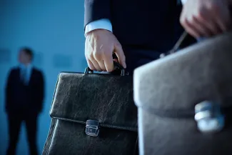 Business people holding briefcases