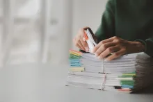 Woman looking through stack of legal documents
