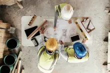 Construction workers looking at plans.