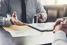 Two people at desk in dispute